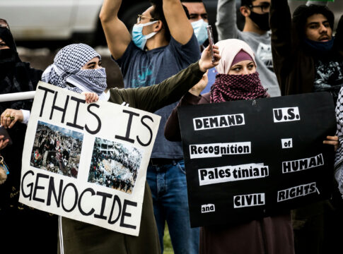 Protesters holding signs at a rally