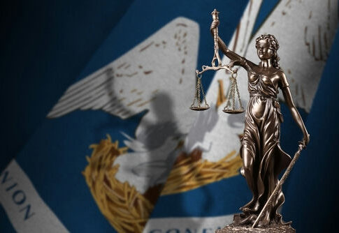 Lady Justice statue with Louisiana state flag background.